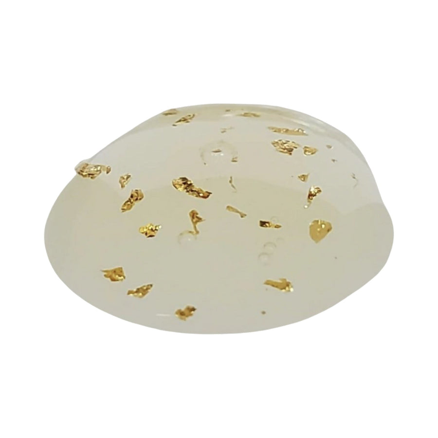 Close-up of Golden Beauty formula with real 24K gold flakes suspended in it